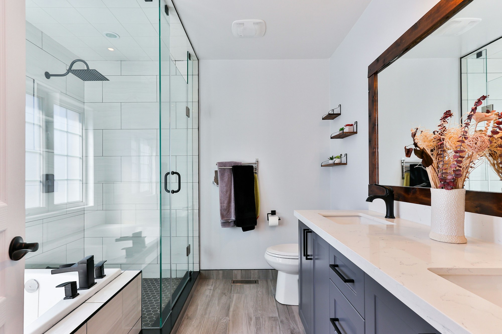 Frameless glass shower enclosure and vanity mirror — Perfect Panes Glass installation